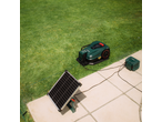 PARKSIDE battery-powered robotic lawnmower, charged by a solar panel in a garden.