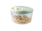 A mint green manual food chopper with chopped nuts inside.