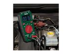 Digital multimeter displaying '0016 °C' measuring temperature in a car engine.