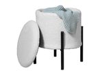 White bouclé storage ottoman with black legs and a light blue knitted blanket inside.