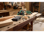 Woodworking tools: electric planer, jigsaw, and chisels on a wooden workbench.
