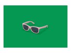 Pink sunglasses with dark lenses on a green background.