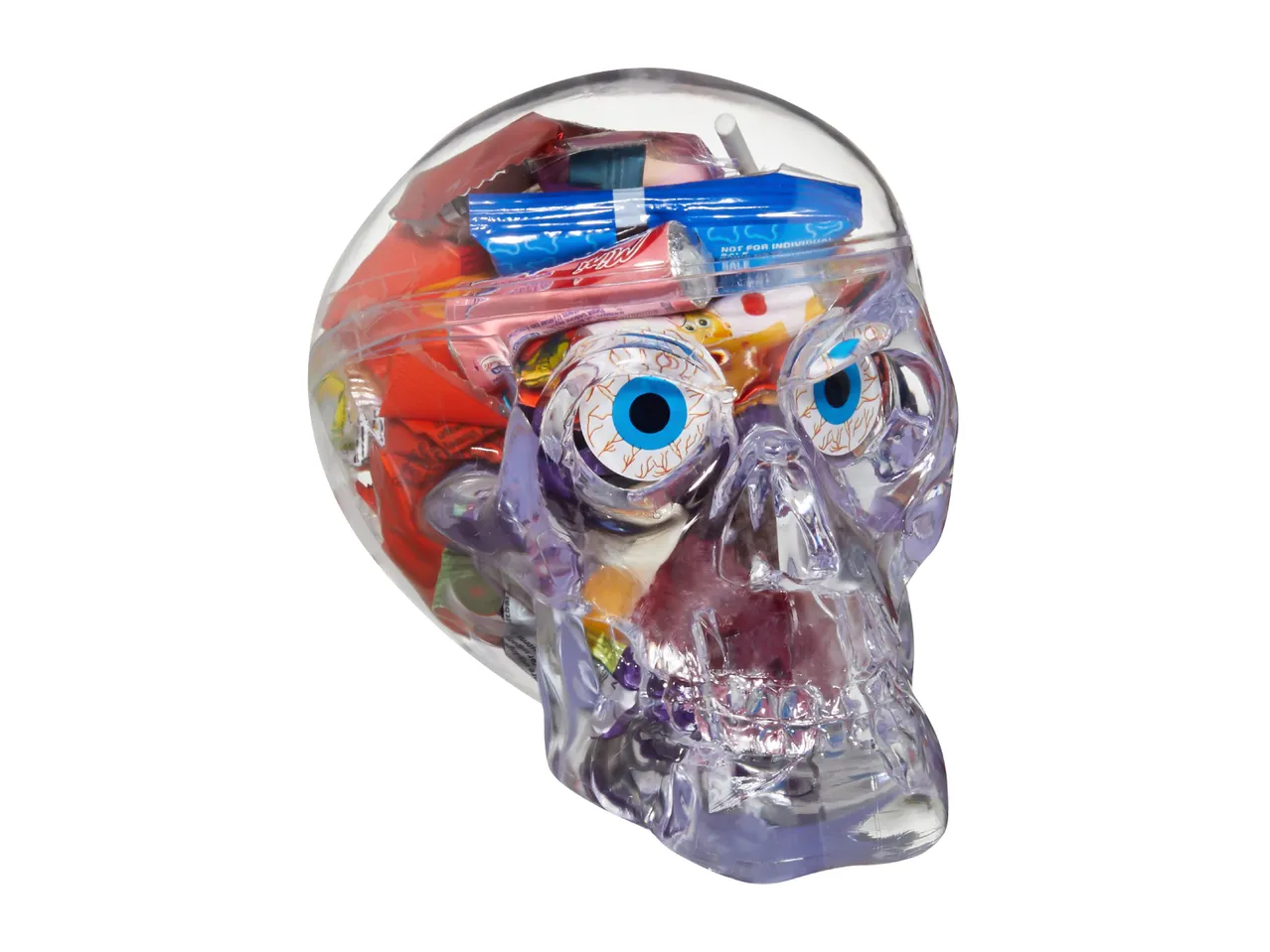 Clear plastic skull-shaped container filled with colorful Halloween candies and eyeball sweets