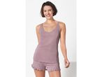 Woman modeling a mauve sleeveless top and shorts pajama set.