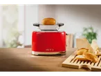 Red toaster with a bun on top, and bread rolls on a wooden board.