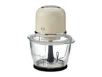 Electric food chopper with a cream-colored motor unit and a glass bowl with measurement markings