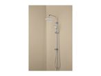 Chrome shower system with a large overhead shower and a handheld shower, water running.