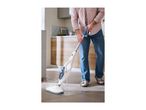 Man cleaning kitchen floor with a steam mop