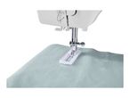 A sewing machine with a buttonhole foot on light blue fabric.