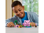 A child plays with LEGO Minecraft: a pink pig and other characters.