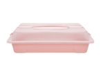 Lyserød kageboks med gennemsigtigt låg og håndtag