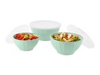Three mint green bowls with white lids, two filled with salads, on a white background.