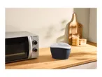 Microwave and popcorn maker on a wooden kitchen counter.