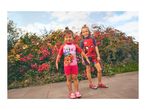 Two children in swimsuits, one with Paw Patrol print, the other with a superhero print.