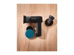 A black electric cleaning brush with various attachments, including a brush and scrubbing pads, on a wooden surface.