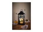 Halloween lantern with raven silhouettes, pumpkins, spiders, and cobwebs on a wooden surface.