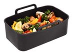Black silicone air fryer basket filled with colorful chopped vegetables.