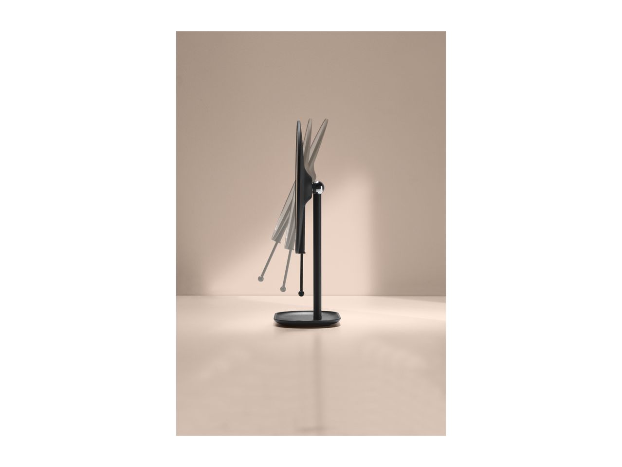 Black monitor on a stand, showing its tilt adjustment range against a beige background.