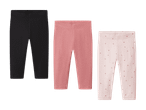 Tre par leggings til børn: et sort, et rosa og et lyserødt med prikker.