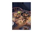 Table set with paninis, a skillet with food, salad, and drinks on a wooden table.