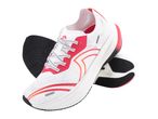 Pair of white running shoes with red and orange accents, black soles, and white laces.