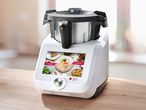 A white and black Monsieur Cuisine Smart food processor with a digital screen displaying recipes.