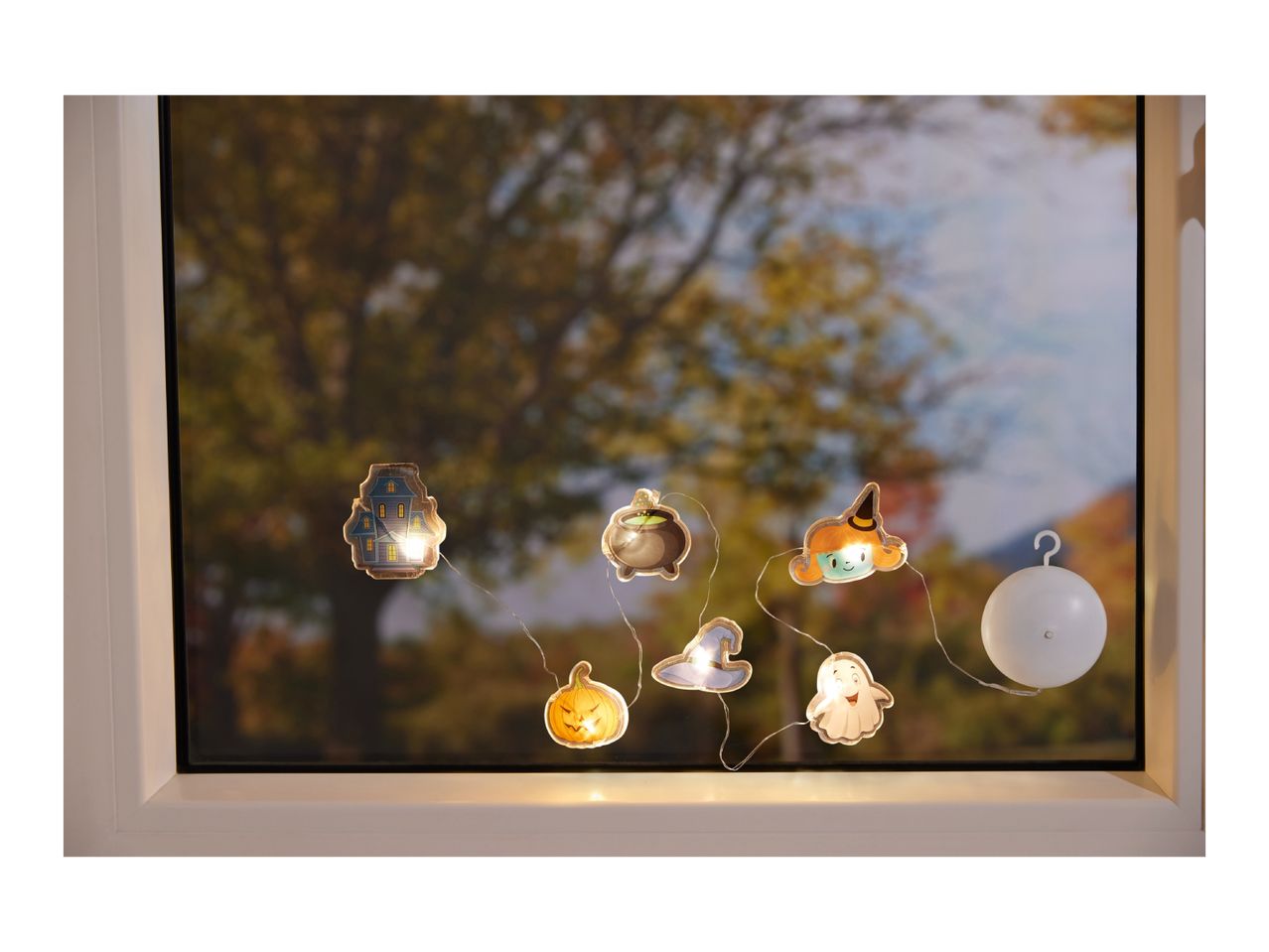 Halloween string lights with haunted house, cauldron, witch, pumpkin, and ghost shapes.