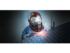 Person welding with a PARKSIDE® Automatic Welding Helmet, sparks flying.