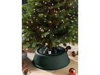 LIVARNO home Christmas Tree Stand in dark green, holding a lit Christmas tree.
