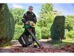 Man uses a Parkside® leaf blower to clear leaves from a path.