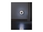 A night light plugged into a wall socket, illuminating a dark hallway.