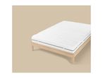 White mattress with a striped pattern on a light wooden bed frame.