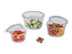 Three glass food storage containers with lids, filled with vegetables and rice.