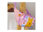 Pink fanny pack with a cartoon bear and floral pattern, hanging on a wooden rack.
