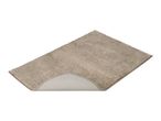 Beige bath mat with a non-slip backing partially visible