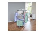 White clothes drying rack with various clothes and towels, next to a washing machine.