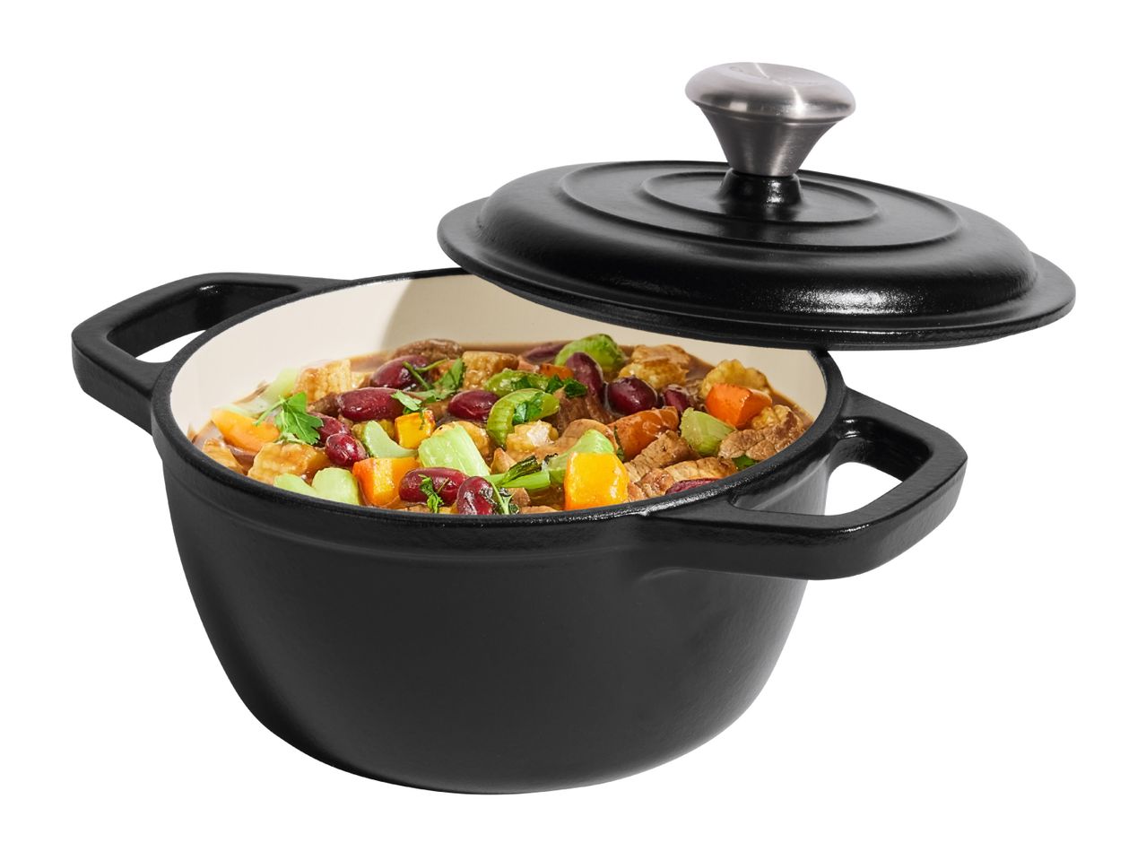 Black cast iron pot with lid, filled with a colorful stew of vegetables and beans.