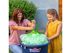 A woman and child filling Zuru Bunch O Balloons water balloons in a blue bucket.
