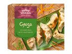 Frozen gyoza dumplings with vegetables on a green plate, with a bamboo pattern background.