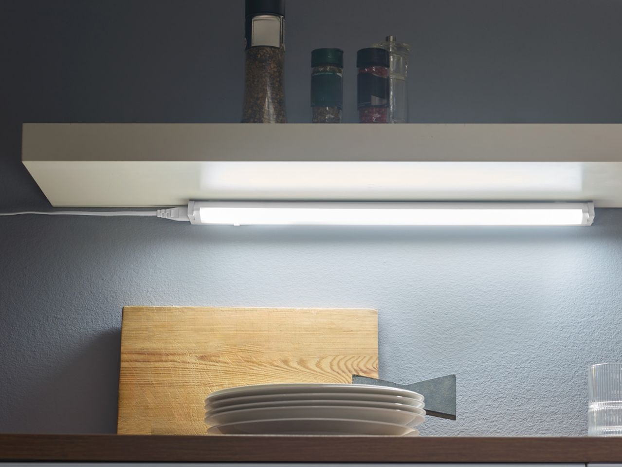 Under-cabinet LED lighting illuminates a kitchen countertop.