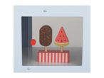 Wooden toy ice cream and watermelon popsicle on a striped stand inside a display case.