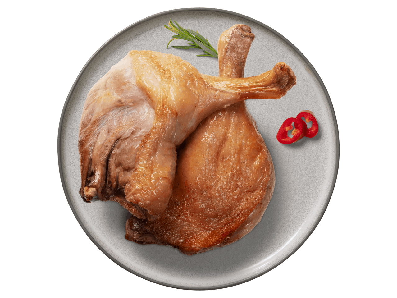 Két sült kacsacomb tányéron, rozmaringgal és chilivel díszítve.