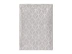 A light grey bath mat with a textured leaf pattern.