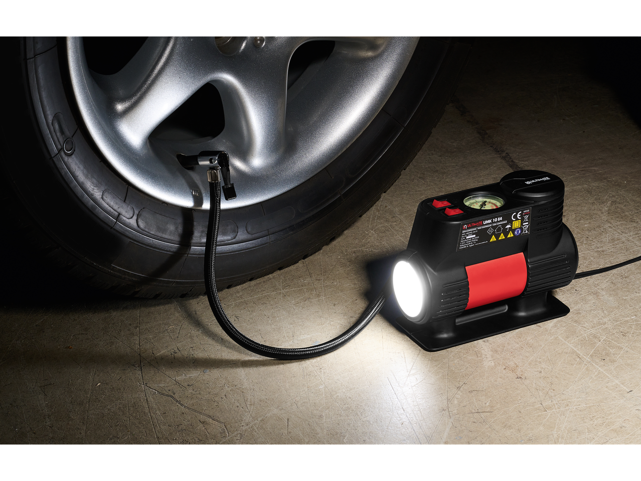 Ultimate Speed mini compressor inflating a car tire.