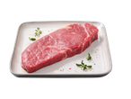 Bife Angus Rib Eye fresco com ervas e especiarias num prato branco