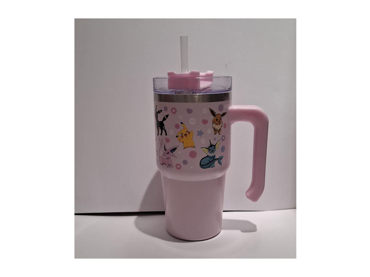 Pink plastic tumbler with handle and straw, featuring a cute cartoon design.