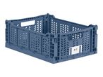 A blue foldable storage crate with a label reading '#1' on the side.