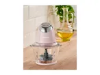 A pink SilverCrest food chopper on a wooden counter with a bottle of oil and a plant in the background.