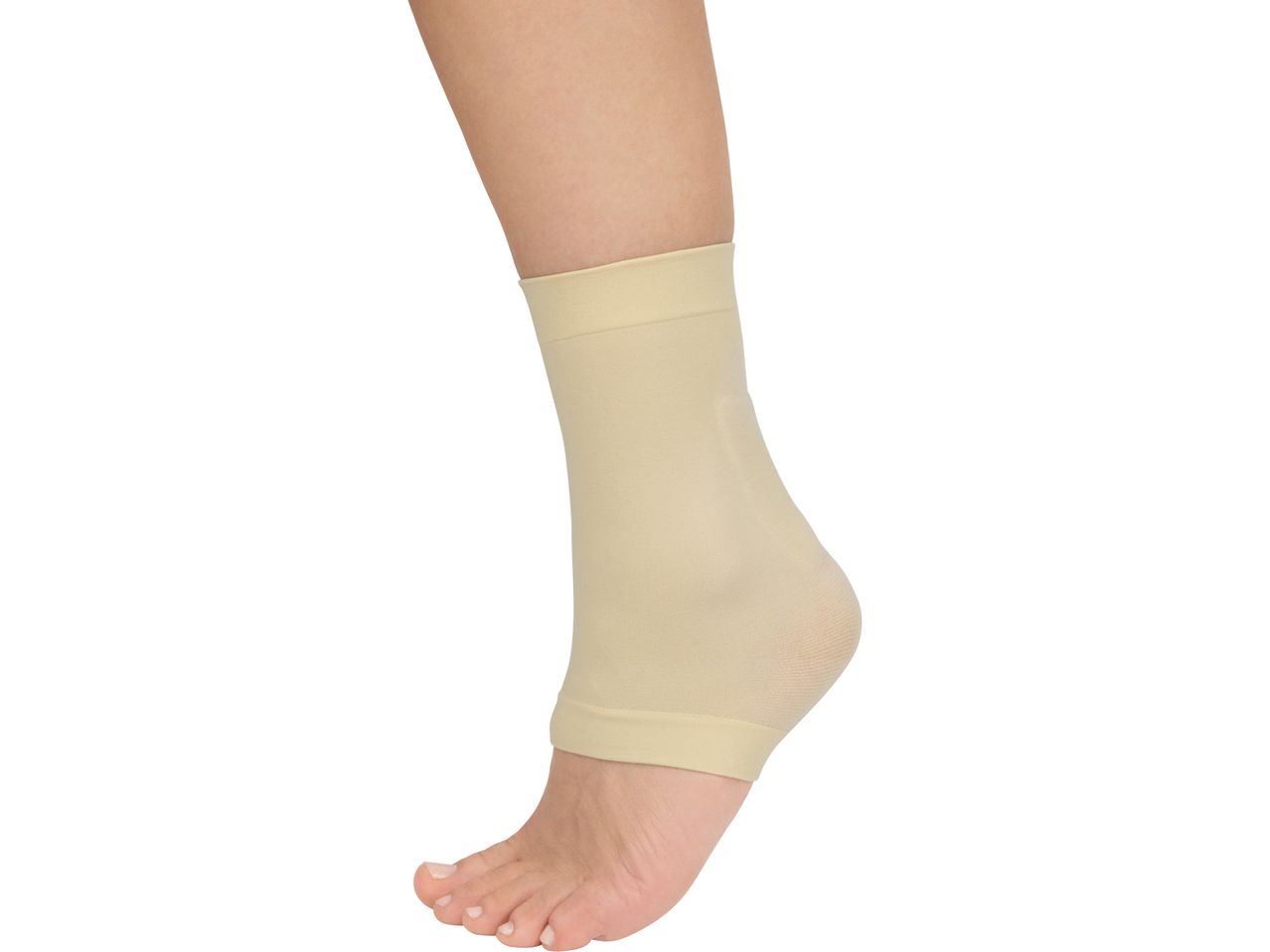 A person's foot and lower leg wearing a beige ankle support sleeve.