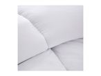 Close-up of a white quilted duvet or mattress protector, showing stitching and texture.